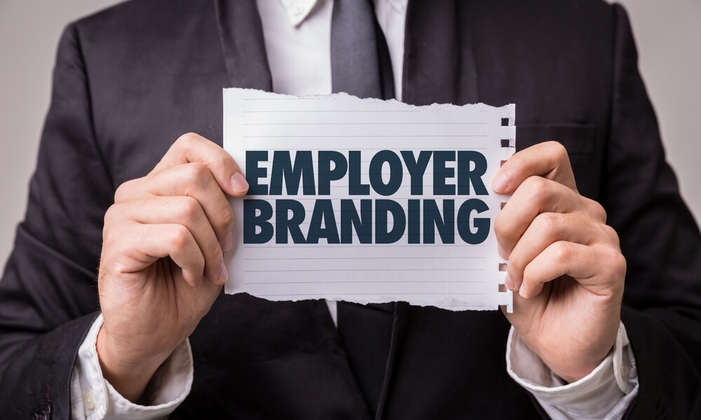 Man holding employer branding sign